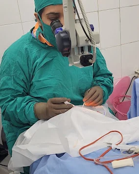 Dr. Anyatama Bhuiyan performing an eye procedure using a surgical microscope